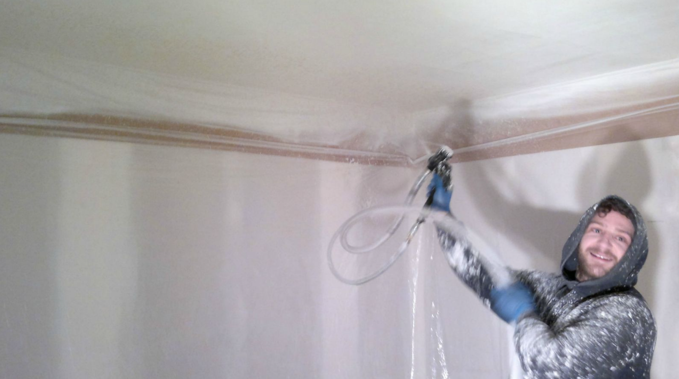 Ceiling texture being professionally applied in a protected room
